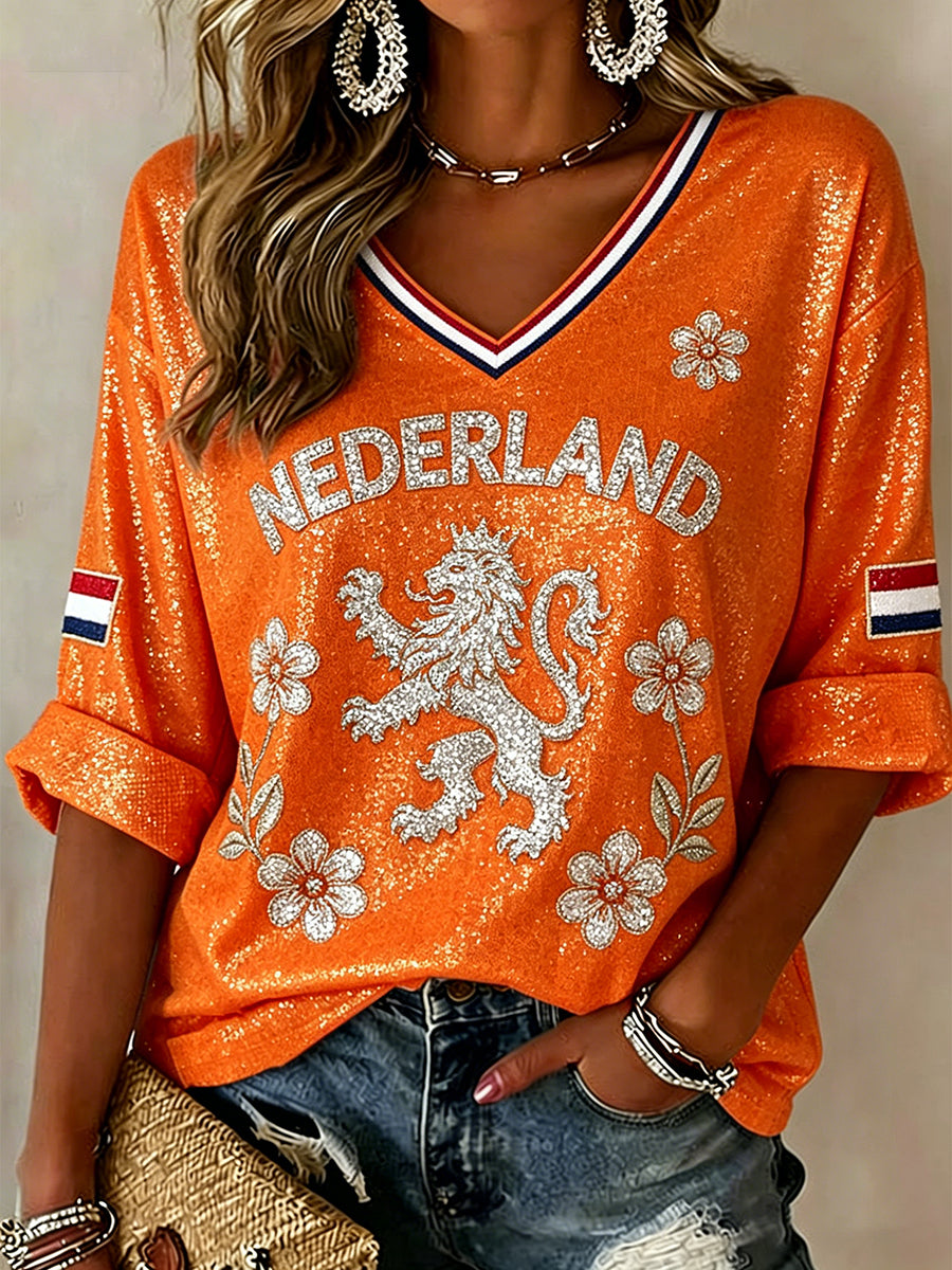 Damestop met pailletten, leeuw- en bloemenprint en V-hals