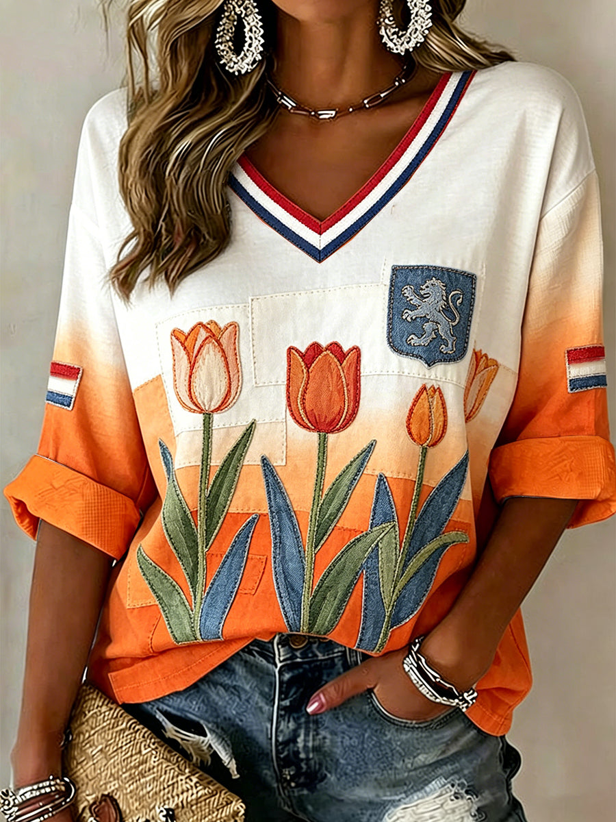 Damesblouse met bloemenpatchworkprint en v-hals in verloopkleuren