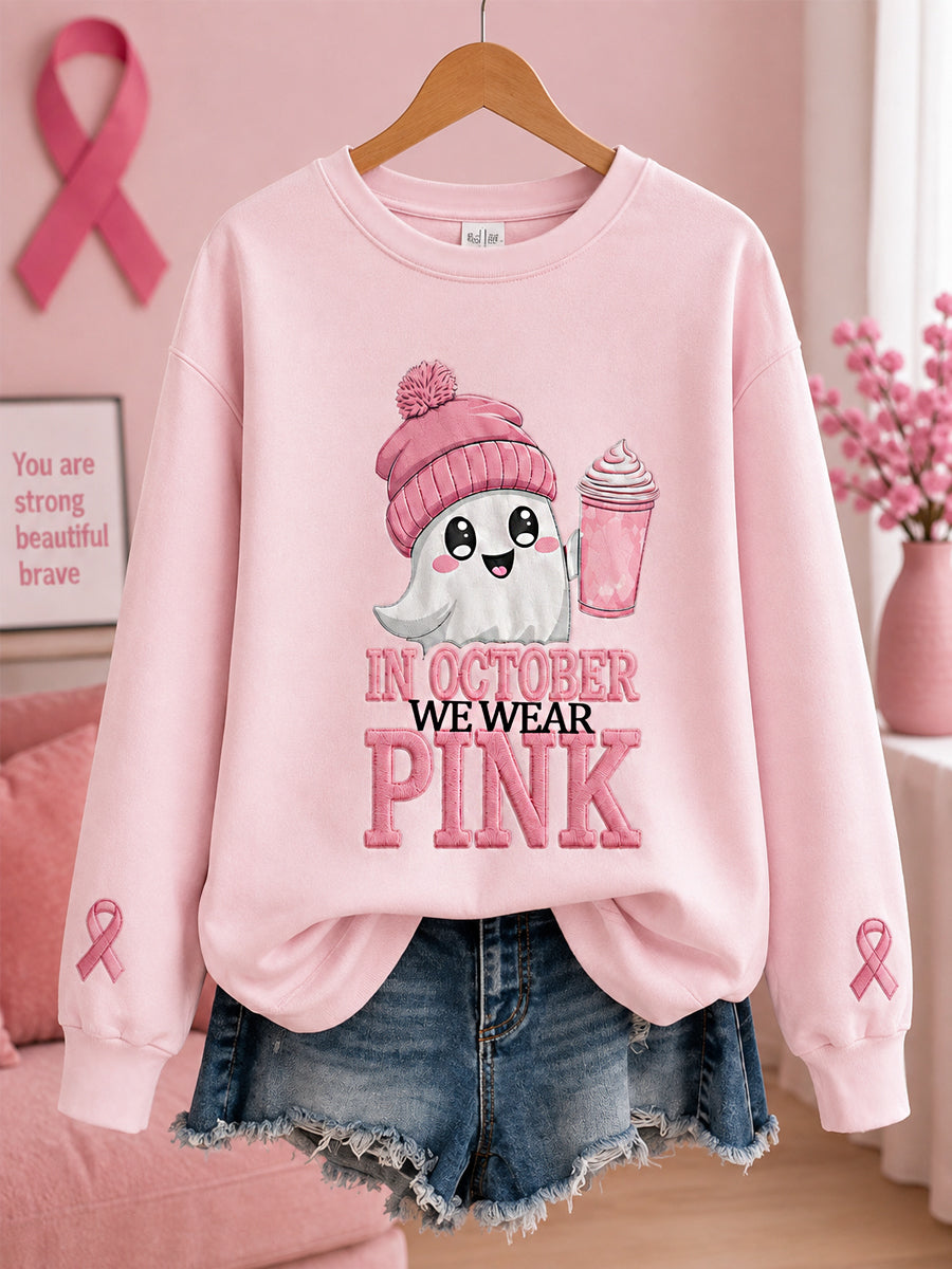 Damesjumper in oktober dragen we roze met pompoen- en spookprint ter ondersteuning van borstkankerbewustwording