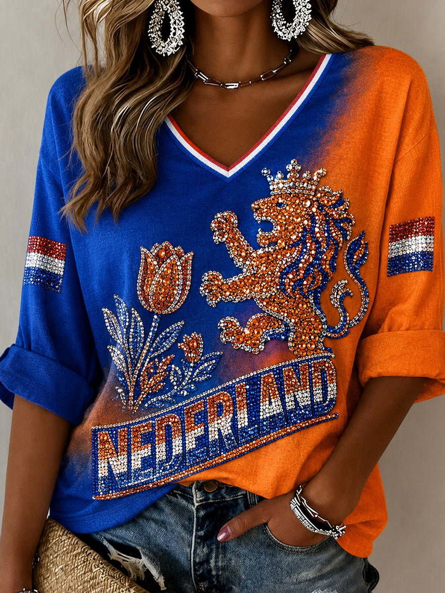 Damestop met lovertjes, leeuwen- en bloemenprint en V-hals