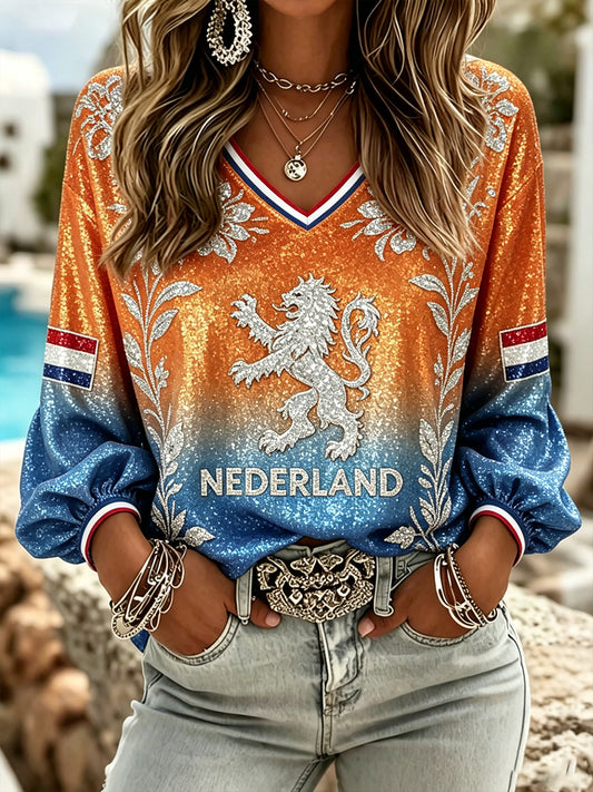 Damestop met lovertjes, leeuwen- en bloemenprint en V-hals